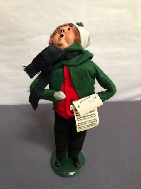 Man in green, red & black with music sheet