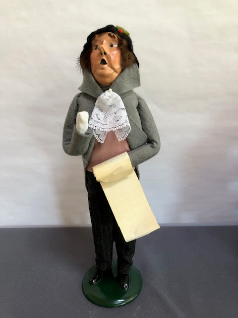 Man in grey, pink & black with music sheet