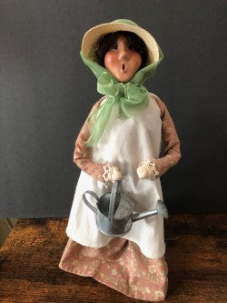 Gardening Lady in Light-brown floral dress with watering can