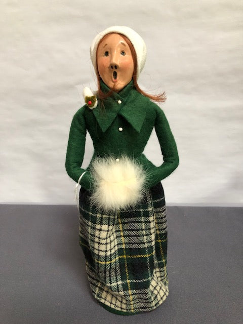 Woman in green and plaid with white muff