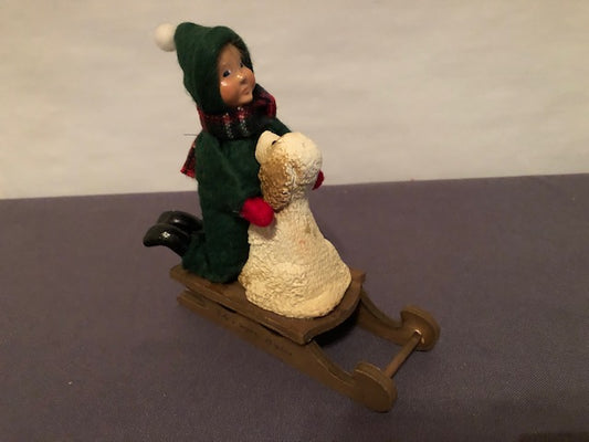 Toddler on sled with dog (signed by Joyce and Bob)