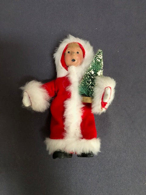 Toddler in Santa suit with tree