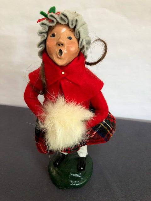 Girl in red and plaid with cream fur muff