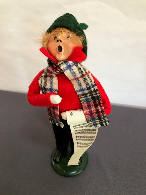 Boy in red & black with plaid scarf and music sheet