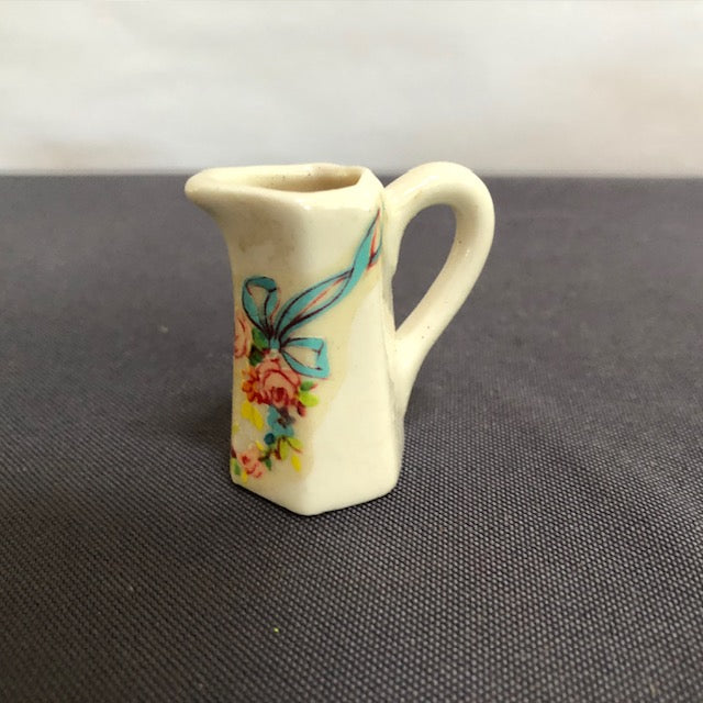 ceramic pitcher with printed floral wreath pattern