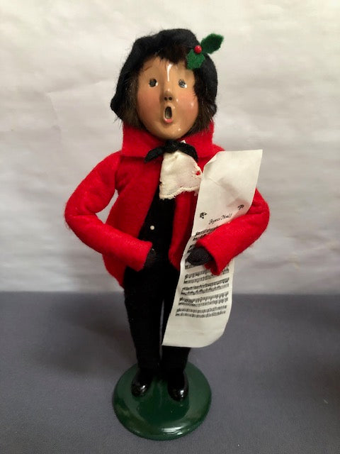 Boy in red coat with black pants and hat