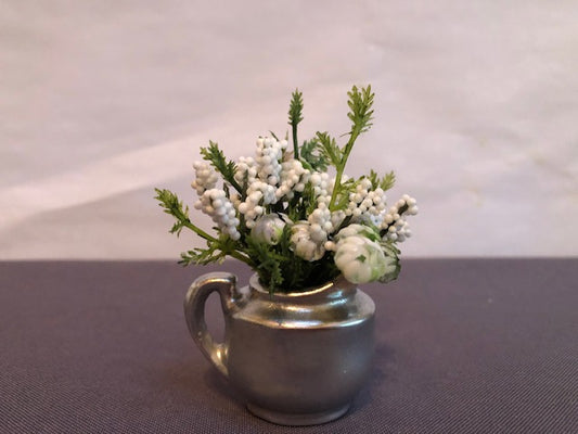 Silver pitcher with white flowers