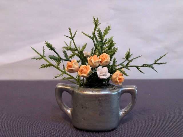 Peach & white clay roses in silver double handled vase