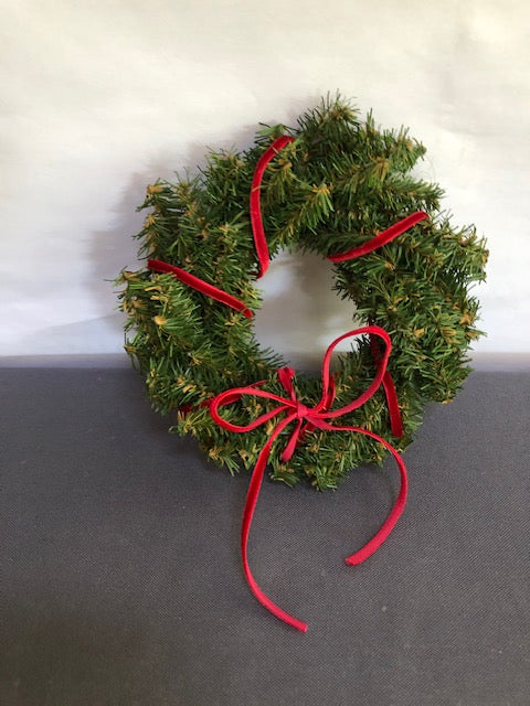 large pine wreath with red velvet bow