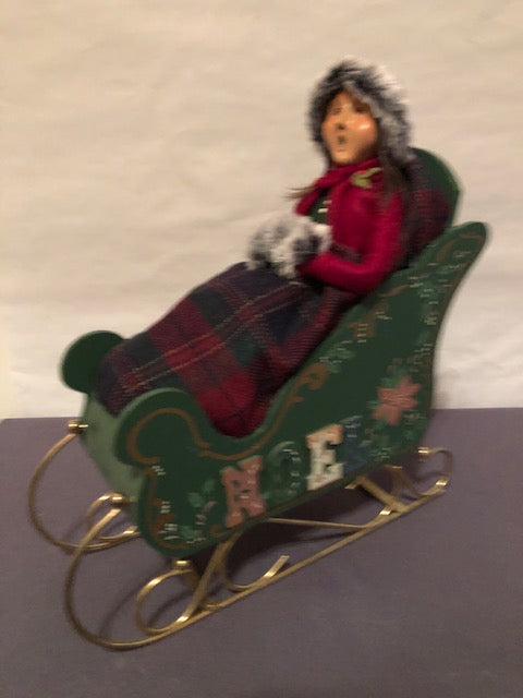 Lady in green noel sleigh with plaid blanket (redressed caroler)