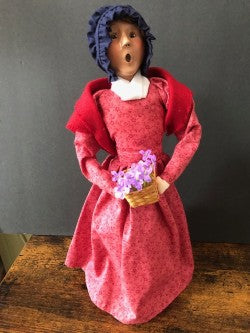 Woman in Red with flower basket and blue hat